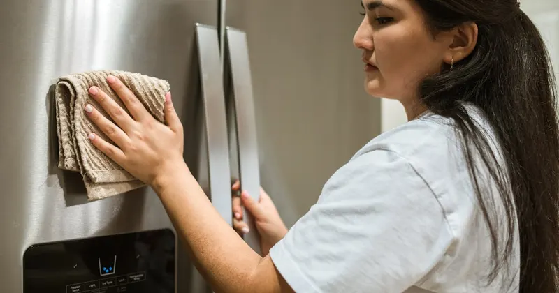 Person mixing natural cleaning solution in a spray bottle