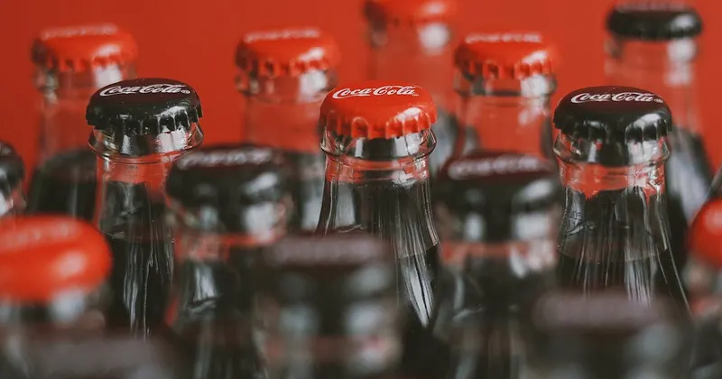 Row of sealed club soda bottles ready for cleaning hacks