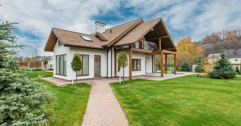 Couple carrying moving boxes into their new home
