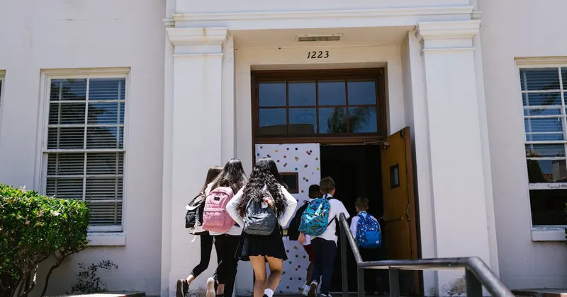 Students with backpacks heading back to school in autumn