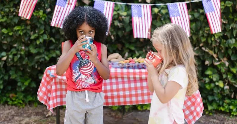 Festive Fourth of July picnic spread with American flags and BBQ