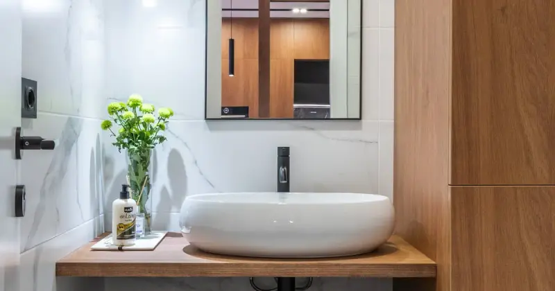 Spacious bathroom featuring elegant marble shower and dark cabinetry.