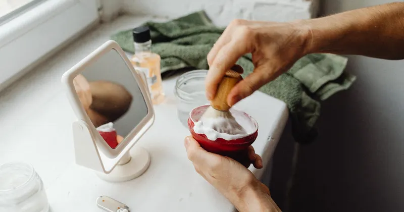 Person with cleaning supplies in bright home interior