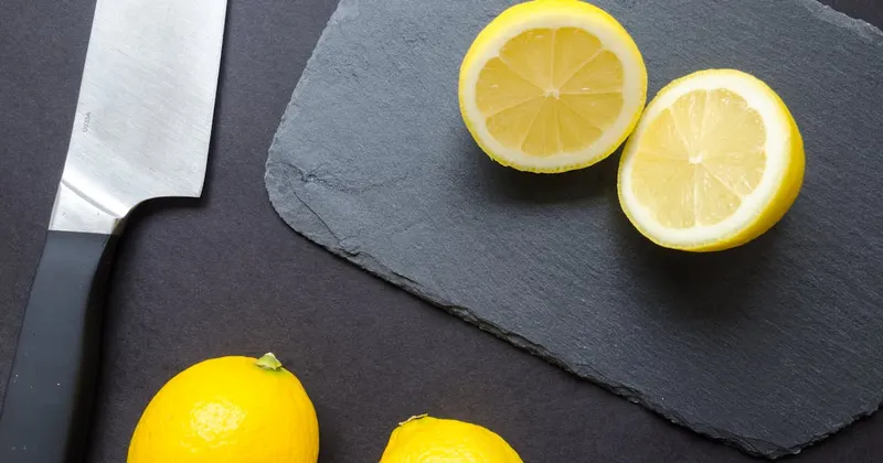 Sliced lemons on a black surface ready for use