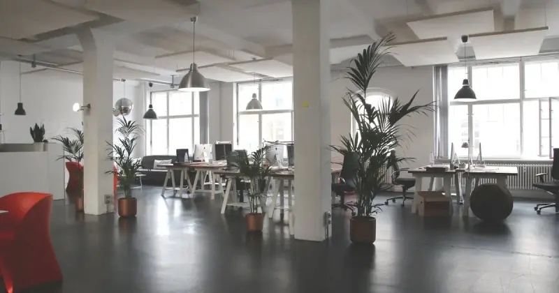 Office desk workspace being professionally cleaned