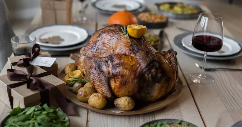 Thanksgiving dinner table with tasty dishes and wine for hosting