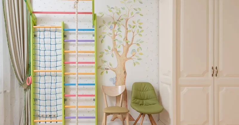 Interior of light playroom with colorful climbing wall and zones