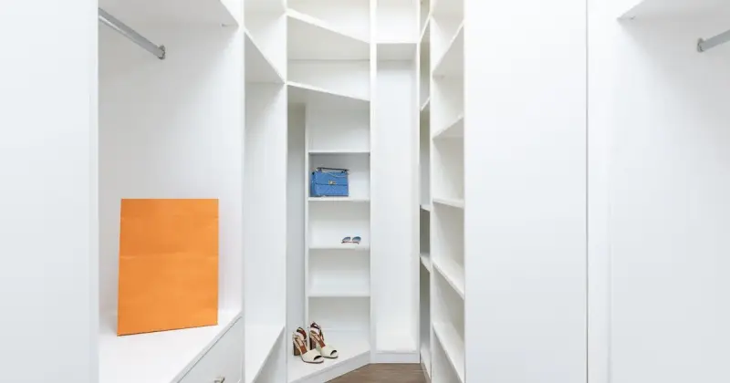 Modern white wardrobe with organized shelves and clean linens