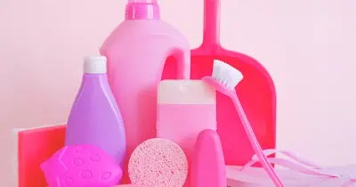 Clean white shelf with a spray cleaner and wooden caddy, perfect for home organization.