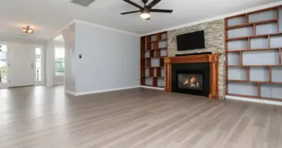 Newly renovated kitchen with construction dust being cleaned from countertops