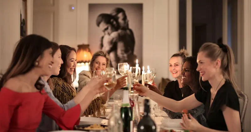Group of people at a dining table enjoying dinner party