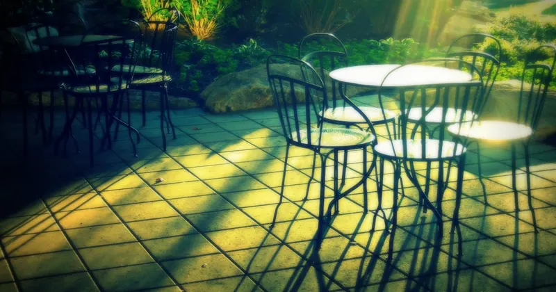 Outdoor patio chairs and deck furniture in a garden setting