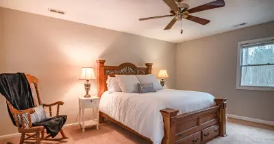 Elegant neutral-toned bedroom with plush bedding, perfect for vacation rentals or Airbnb listings.