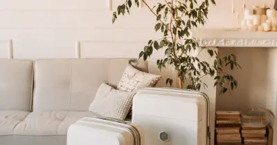 Packed suitcase standing in a living room ready for summer vacation