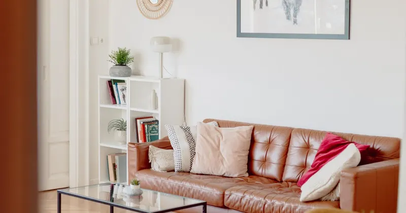 Living room with brown leather sofa and glass coffee table
