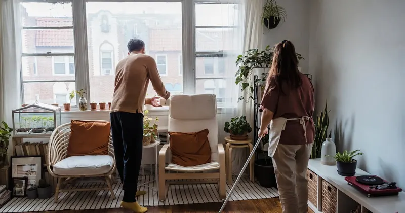 A couple cleaning the floor together