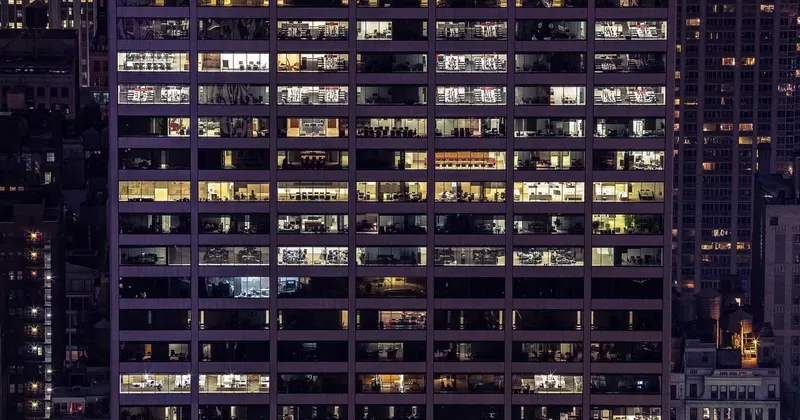 Person wiping the interior of a stainless steel refrigerator