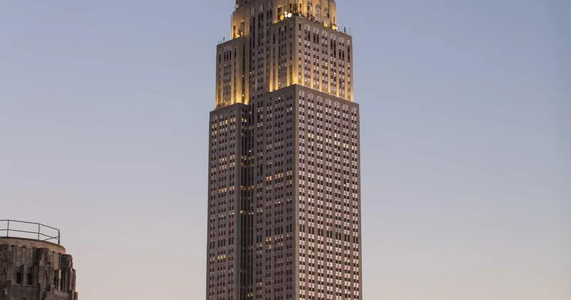 Modern bathroom with streak-free glass shower door and marble tiles